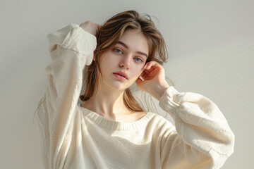 Fototapeta premium portrait of a fashion young woman in a studio muted color background and minimalistic