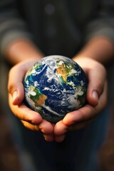 Hands holding an Earth globe - obrazy, fototapety, plakaty