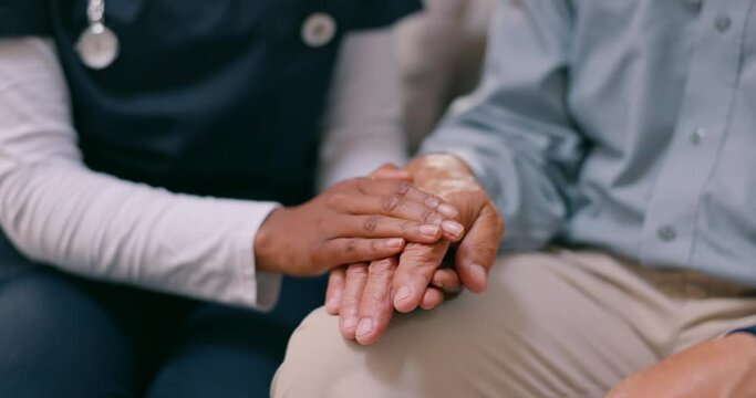 Holding hands, senior person and nurse with care, comfort or support in grief, mental health or anxiety in home. Caregiver, doctor and elderly patient with empathy, kindness and closeup in retirement