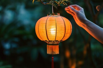 A hand is holding a Chinese lantern in a romantic scene