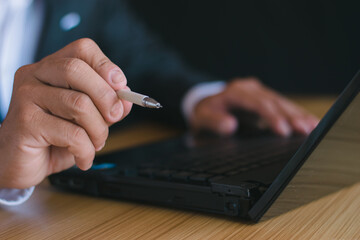 Close-up of business people working with notebook computers and using mobile phones, chatting, talking, working in the office desk of the office