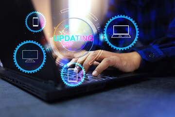 Software update concept with user hand working on laptop computer to updating program feature for...