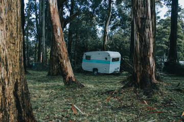 Abandoned caravan in forest 