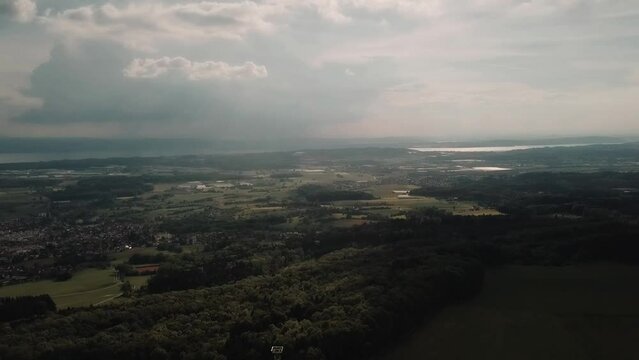 A drone slowly pans left over the woodlands surrounding Lake Constance