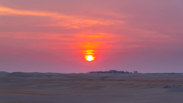 Beautiful dramatic clouds sunset sunrise time lapse over the desert sand dune of Abu Dhabi, UAE