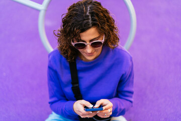 Focused woman browsing smartphone on playground - 712933357