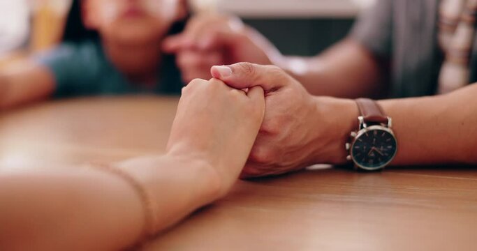 Family, holding hands and praying at table in home for faith in God, spiritual or gratitude with trust. Prayer, people or closeup of religion, understanding and thankful for blessing, grace or Christ