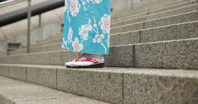 Feet, stairs and person in Japanese kimono for travel, tourism or Tokyo sightseeing closeup. Sandals, steps and culture with tourist outdoor in clothes for tradition, vacation or holiday adventure