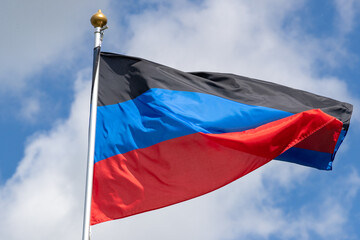 Flags of Russia, Donetsk People's Republic. The Donetsk and People's Republics are partially recognized state entities in Eastern Europe. Flag against the blue sky. Great for news.