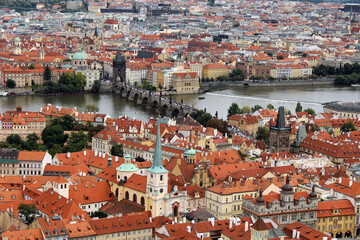 Fototapeta na wymiar Panorama of Prague Old Town with red roofs famous Charles bridge and Vltava river,