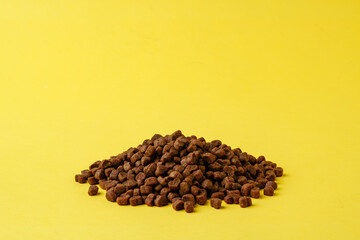 Cat food on yellow background studio shot