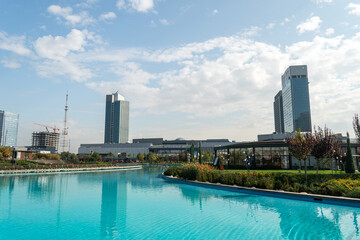 Obraz premium Awesome view of contemporary buildings reflected in pool of Tashkent City Park in Tashkent, Uzbekistan. The park is a popular recreational gathering place among residents and tourists.