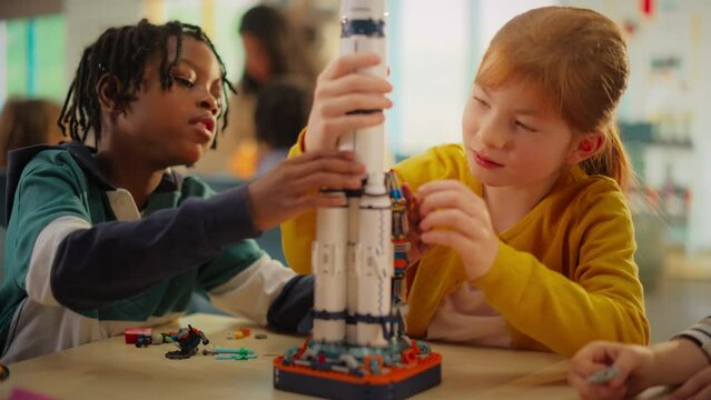 Smart Boys and Talented Girls Making a Model of a Modern Multiplanetary Space Rocket. Young Gifted Future Engineers Studying Science, Engineering, Space and Technology in Primary STEM School