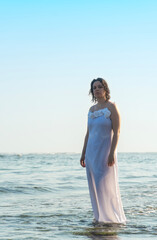 Fototapeta na wymiar Bride looking at camera on ocean shores
