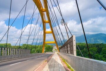 Niseko Bridge, the yellow bridge spanning across the Hakodate Main Line and Shiribetsu River, connecting the north and south of Niseko, Shiribeshi Subprefecture, Hokkaido, Japan