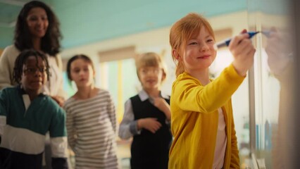 Talented Small Girl Solving an Arithmetic Equation that a Teacher Gave Her. Portrait of a Happy Elementary School Pupil Studying Hard, Writing a Correct Answer on a Whiteboard During a Math Class - Powered by Adobe