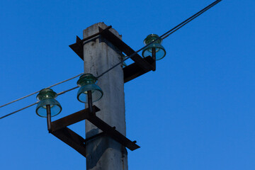 high voltage pole against blue sky