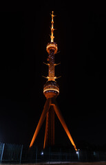 Tashkent television tower illuminated by night illumination at nighttime on a sky background.