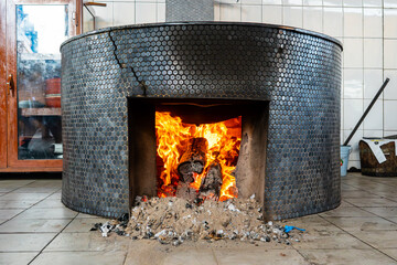 fire heats up a large cooking pot.