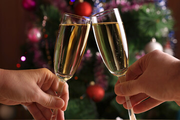 In the background, Christmas trees with twinkling garlands offer toasts with glasses of champagne