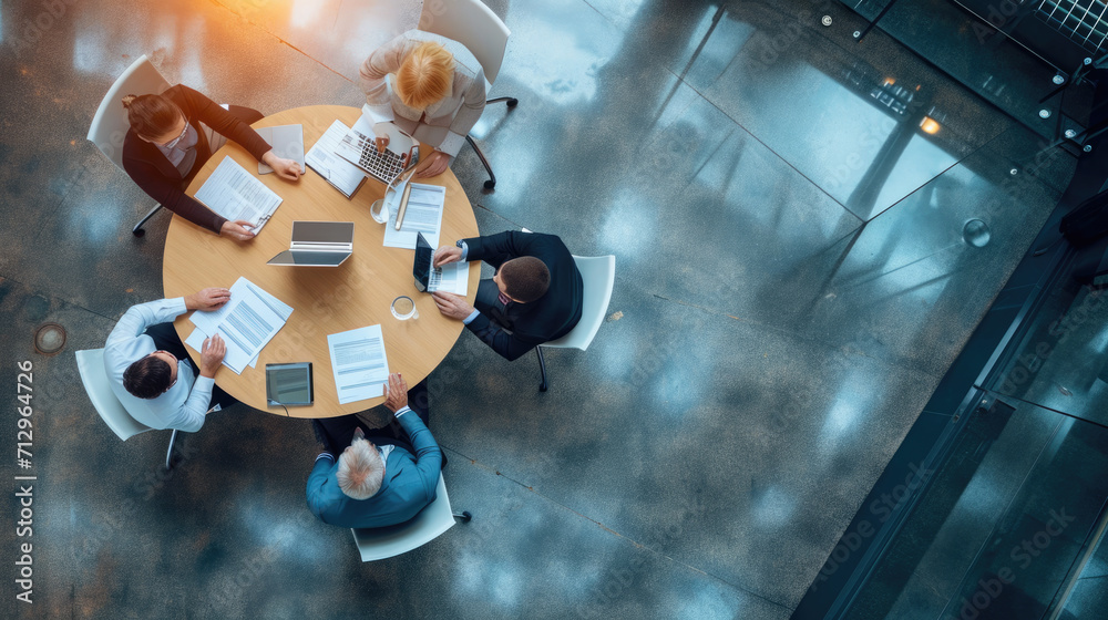 Canvas Prints aerial view of a professional meeting with four individuals around a round table