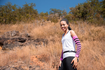 Naklejka na ściany i meble Portrait of Happy beautiful african American woman runner smiling after exercising, Healthy female living confidently and outdoors fitness. Fitness woman taking a break after running workout.