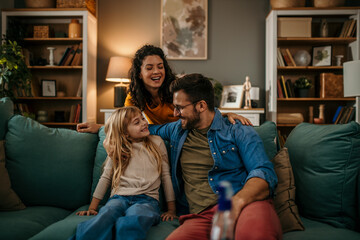 A happy family chatting and connecting on the couch in their living room