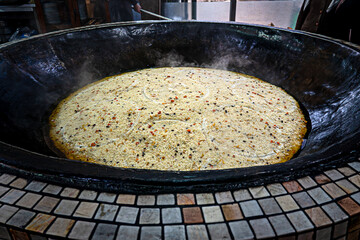 Cooking of plov in the Kazan cauldron at the Central Asian Plov Centre, Tashkent, Uzbekistan