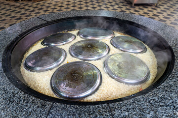 Cooking of plov in the Kazan cauldron at the Central Asian Plov Centre, Tashkent, Uzbekistan
