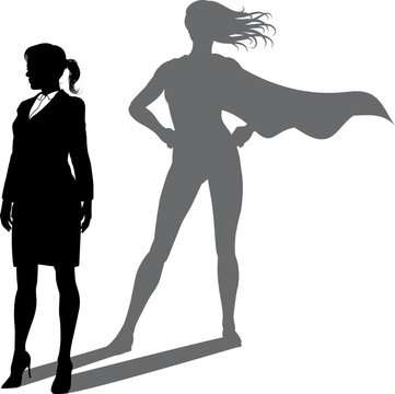 A superhero business woman revealed by her shadow silhouette as a super hero in a cape