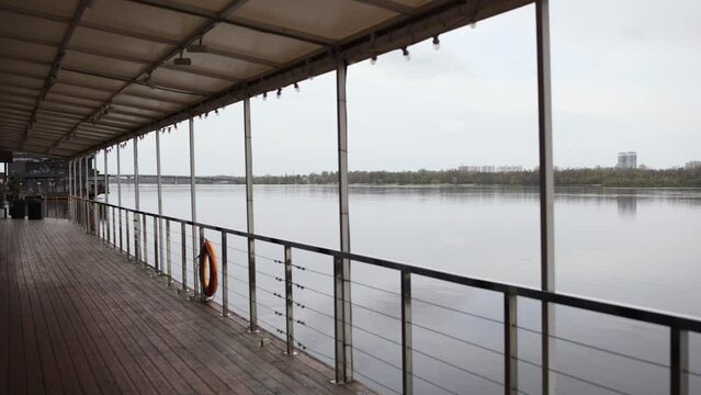 veranda of a restaurant on the water a ship with a deck on the river