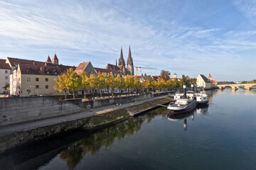 Fototapeta na wymiar Regensburg on the Danube with stone bridge in sunshine and clouds in autumn