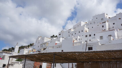Fototapeta na wymiar Beautiful white buildings under the blue cloudy sky in beautiful Morocco
