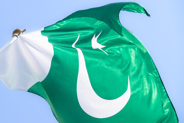 National flag of Pakistan. Pakistan flag against blue sky. Great for news. Waving flag of Pakistan