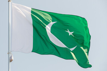 National flag of Pakistan. Pakistan flag against blue sky. Great for news. Waving flag of Pakistan