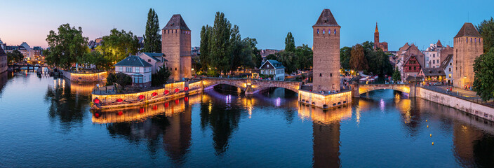 Panoramic view on The Ponts Couverts in evening twilight. Strasbourg with blue cloudy sky. France. - obrazy, fototapety, plakaty