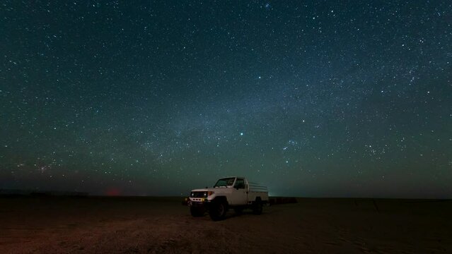 Time lapse of night Stars motion with Gemini Meteors shooting in safari desert camping camel farm Bedouin