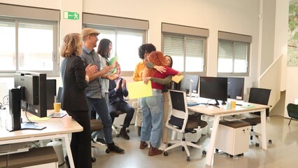 Joyful office team celebrates with hugs and cheers