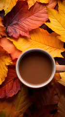 A steaming cup of coffee or tea nestled among colorful fallen autumn leaves.
