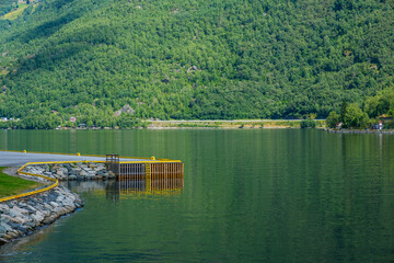 Fototapeta premium On the fjord journey from Bergenden to Flam you will see nature, mountains, sea, waterfalls, fishing towns, boats 