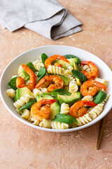 Pasta salad with shrimps, avocado and spinach. Healthy eating. Seafood.