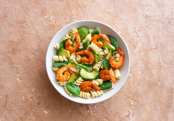 Pasta salad with shrimps, avocado and spinach. Healthy eating. Seafood.