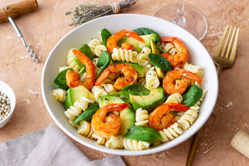 Pasta salad with shrimps, avocado and spinach. Healthy eating. Seafood.