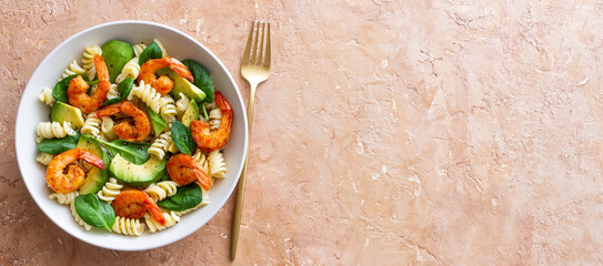 Pasta salad with shrimps, avocado and spinach. Healthy eating. Seafood.