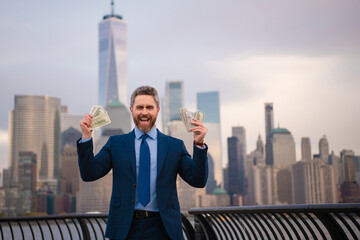 Businessman hold money dollars in New York. Businessman with dollar outdoor. Wealth rich...