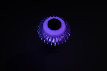 Color changing spiral decorative LED wireless Speaker Bulb light illuminated in purple color light, closeup