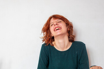 close-up portrait of a pensive teenage girl with red hair with a stylish anime hairstyle