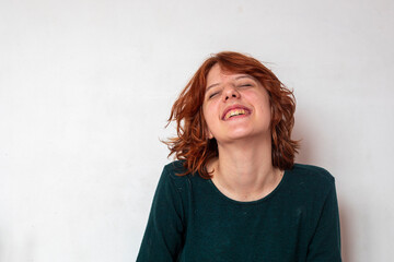 close-up portrait of a pensive teenage girl with red hair with a stylish anime hairstyle