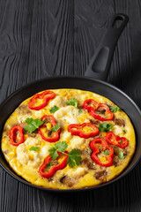 omelette with vegetables in a pan, top view