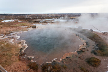 Geysir crater with boiling water in winter in Iceland